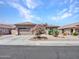 Charming single-story home featuring desert landscaping, mature trees, and a two-car garage, on a sunny day at 230 S 122Nd Ln, Avondale, AZ 85323