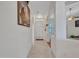 Clean and bright hallway with tile flooring and arched doorways at 230 S 122Nd Ln, Avondale, AZ 85323