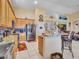 Open kitchen with stainless appliances, granite counters, and an eat-in bar, flowing to the dining and living areas at 230 S 122Nd Ln, Avondale, AZ 85323