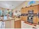 Bright kitchen featuring granite countertops, stainless steel appliances, and ample cabinet space at 230 S 122Nd Ln, Avondale, AZ 85323