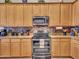 Kitchen featuring stainless steel appliances, granite counters, and light wood cabinets at 230 S 122Nd Ln, Avondale, AZ 85323