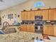 Kitchen with granite counters, stainless appliances, eat-in island, and a view into the dining area at 230 S 122Nd Ln, Avondale, AZ 85323