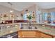 Open kitchen featuring granite countertops, a stainless steel sink, and a view into the living area at 230 S 122Nd Ln, Avondale, AZ 85323