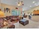 Inviting living room featuring a leather sofa, tile flooring, and a view of the dining area and kitchen at 230 S 122Nd Ln, Avondale, AZ 85323