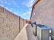 Spacious side yard with low-maintenance gravel, a block wall for privacy, and mature landscaping creating a clean aesthetic at 230 S 122Nd Ln, Avondale, AZ 85323