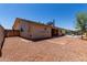 Rear exterior showcasing a gravel yard and covered patio with pool in background at 2330 E Elmwood St, Mesa, AZ 85213