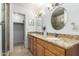Bathroom features a double vanity with granite countertops and stylish lighting fixtures at 2330 E Elmwood St, Mesa, AZ 85213