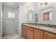 Bright bathroom with a dual sink vanity with granite countertops and warm lighting at 2330 E Elmwood St, Mesa, AZ 85213