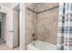 Well-lit bathroom featuring a tiled shower and updated fixtures at 2330 E Elmwood St, Mesa, AZ 85213