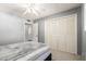 Bedroom with a double door closet, neutral paint, and access to the hallway at 2330 E Elmwood St, Mesa, AZ 85213