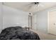 Neutral bedroom with a ceiling fan, access to an adjacent room, and large closet at 2330 E Elmwood St, Mesa, AZ 85213