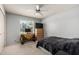 Bedroom featuring a window, ceiling fan, TV, and neutral carpeting at 2330 E Elmwood St, Mesa, AZ 85213