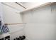 This walk-in closet features rods for hanging clothes and space for shoe storage at 2330 E Elmwood St, Mesa, AZ 85213
