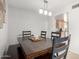Bright dining area with a dark wood table and four chairs next to kitchen at 2330 E Elmwood St, Mesa, AZ 85213