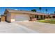 Spacious home featuring an attached garage, green lawn, and front porch at 2330 E Elmwood St, Mesa, AZ 85213