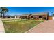 Street view of single-story home with manicured lawn, landscaping and driveway at 2330 E Elmwood St, Mesa, AZ 85213