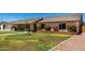 View of front yard of single-story home showing lawn, sidewalk, and brick planters at 2330 E Elmwood St, Mesa, AZ 85213