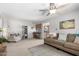 Open-concept living room with a view to the kitchen breakfast bar at 2330 E Elmwood St, Mesa, AZ 85213