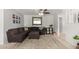 Neutral living room with a comfortable sectional sofa, patterned rug, and decorative mirror at 2330 E Elmwood St, Mesa, AZ 85213