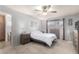 Main bedroom with neutral walls, carpet, a ceiling fan, and adjacent bathroom at 2330 E Elmwood St, Mesa, AZ 85213