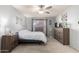 Main bedroom featuring neutral walls, carpet, a ceiling fan, and a large window at 2330 E Elmwood St, Mesa, AZ 85213
