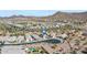 Aerial view of the neighborhood homes with a pool in the backyard, set against a backdrop of scenic mountains at 2354 E Lieber Pl, Phoenix, AZ 85024