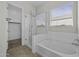 Bathroom with a tub and separate shower stall with glass door and an open walk-in closet at 2354 E Lieber Pl, Phoenix, AZ 85024