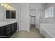 Bathroom featuring a vanity with dark cabinets, a soaking tub, and glass-enclosed shower at 2354 E Lieber Pl, Phoenix, AZ 85024