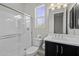 A bathroom with a glass-enclosed shower and vanity with a dark cabinet at 2354 E Lieber Pl, Phoenix, AZ 85024