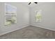 Bright bedroom with neutral carpeting, two windows offering natural light and ceiling fan at 2354 E Lieber Pl, Phoenix, AZ 85024