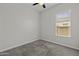 Bedroom showcasing neutral paint, carpet, a ceiling fan and natural light at 2354 E Lieber Pl, Phoenix, AZ 85024