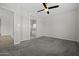 Bedroom featuring a ceiling fan, carpeted floors, and an open view into the bathroom at 2354 E Lieber Pl, Phoenix, AZ 85024