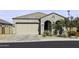 Charming single-story home with a two-car garage, arched entryway, and desert landscaping at 2354 E Lieber Pl, Phoenix, AZ 85024
