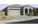 Charming single-story home with a two-car garage, arched entryway, and desert landscaping at 2354 E Lieber Pl, Phoenix, AZ 85024