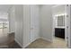Hallway view with access to the bathroom with a vanity and adjacent shower with glass door at 2354 E Lieber Pl, Phoenix, AZ 85024