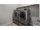 Laundry room featuring a modern washer and dryer with a shelf above at 2354 E Lieber Pl, Phoenix, AZ 85024