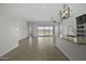 Open-concept living room and kitchen area with tile flooring and a sliding door that opens to the backyard at 2354 E Lieber Pl, Phoenix, AZ 85024