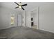 Primary bedroom with carpet, ceiling fan, access to a backyard, and two additional rooms at 2354 E Lieber Pl, Phoenix, AZ 85024
