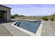 Backyard oasis featuring a sparkling pool, waterfall feature and desert landscaping at 2354 E Lieber Pl, Phoenix, AZ 85024