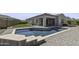 Backyard view with a sparkling pool, artificial grass area and covered patio at 2354 E Lieber Pl, Phoenix, AZ 85024