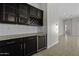 View of the home's wet bar with a granite countertop and an adjacent wine refrigerator at 2354 E Lieber Pl, Phoenix, AZ 85024
