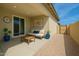 Cozy covered patio area with comfortable seating, potted plants and modern decor elements at 266 N Piedra Way, Mesa, AZ 85207