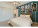 Stylish bedroom with bright accent wall, comfortable bed, ceiling fan, and closet access in a cozy setting at 266 N Piedra Way, Mesa, AZ 85207