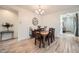 Traditional dining room featuring a wooden table with seating for six underneath a chandelier at 266 N Piedra Way, Mesa, AZ 85207