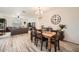 Comfortable dining room with wood floors, wooden table and a large wall clock at 266 N Piedra Way, Mesa, AZ 85207