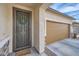 Home featuring a decorative security screen door and a two car garage to the right at 266 N Piedra Way, Mesa, AZ 85207