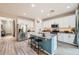 Modern kitchen with white cabinets, granite countertops, a blue island, and stainless steel appliances at 266 N Piedra Way, Mesa, AZ 85207