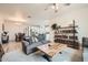 Open-concept living room and dining room featuring a cozy gray sofa and wood accents at 266 N Piedra Way, Mesa, AZ 85207
