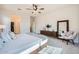 Stylish main bedroom featuring a full length mirror, closet and ensuite bathroom access, and a seating area at 266 N Piedra Way, Mesa, AZ 85207