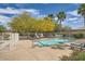 Clean community pool with lounge chairs, shade trees, and well-maintained landscaping at 266 N Piedra Way, Mesa, AZ 85207